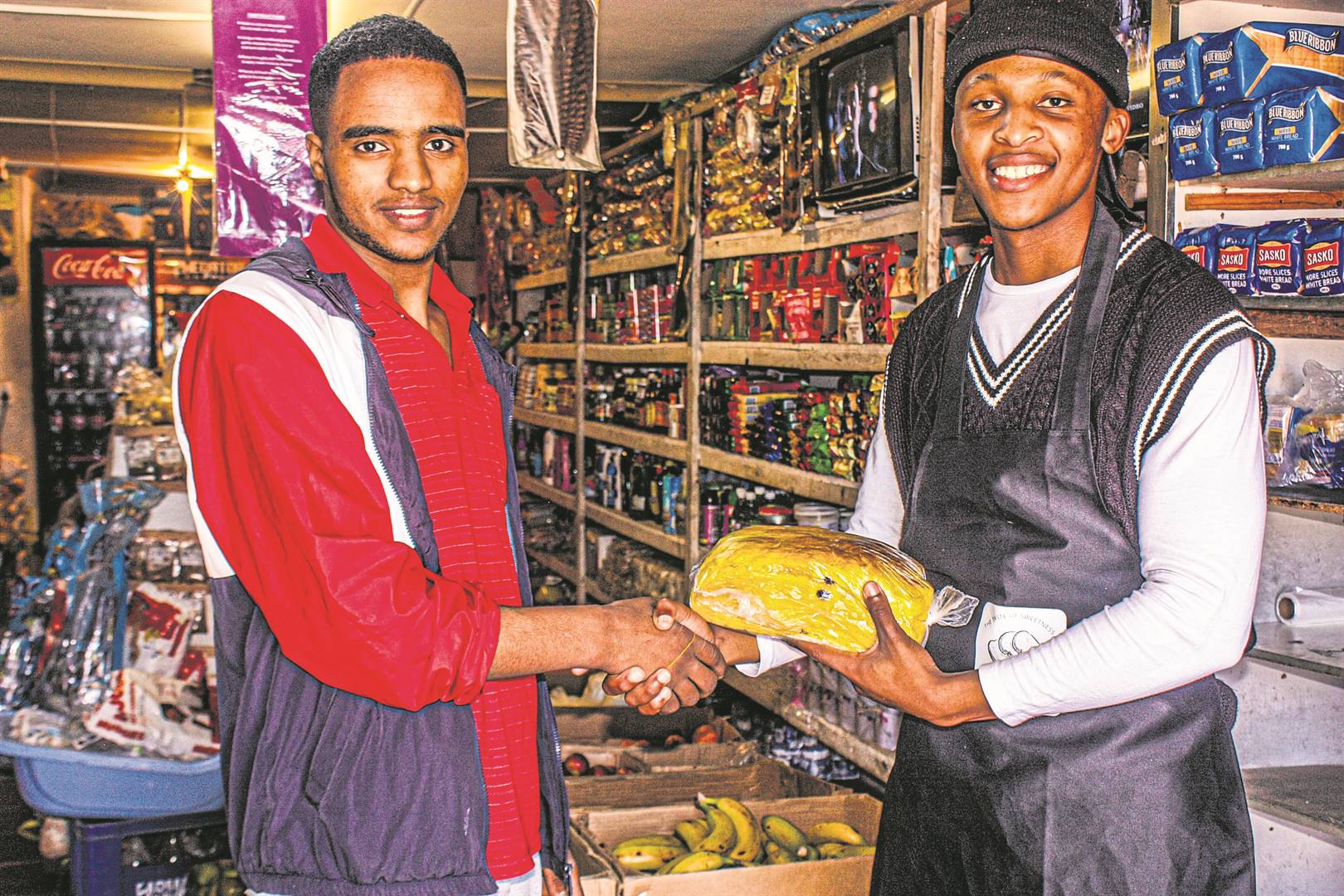 Mandlenkosi Bill (right) from Isonka delivering his freshly baked bread to one of his customers in Despatch. 