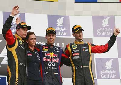<b>BAHRAIN PODIUM GROUP HUG:</b> Lotus F1's Kimi Raikkonen (left), Red Bull's Sebastian Vettel (centre) and Lotus' Romain Grosjean with Red Bull's electronics whizz Gill Jones after the 2013 Bahrain F1 GP on April 21. <i>Image: AFP</i>