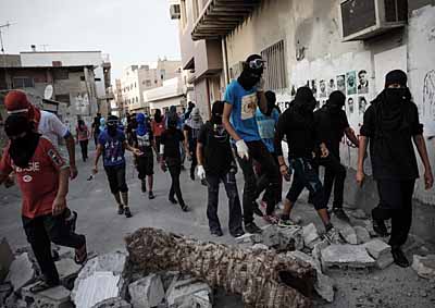 <b>PROWLING PROTESTERS:</b> Bahraini protesters seen during clashes with police after a protest against that country's 2013 F1 GP in the village of Sanabis, west of capital Manama. <i>image: AFP</i>