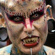 Split tongue, titanium horns and tattoos galore: the lawyer who transformed herself into 'Vampire Woman'