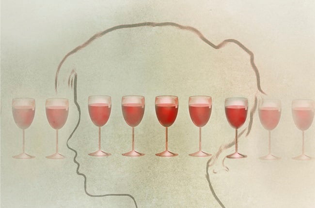 Conceptual illustration of a womans profile and a line of glasses of wine depicting excessive alcohol consumption.