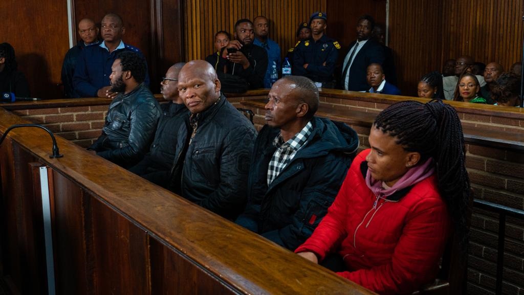Bester's co-accused seated next to each other in court
