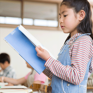 Girl standing while reading 