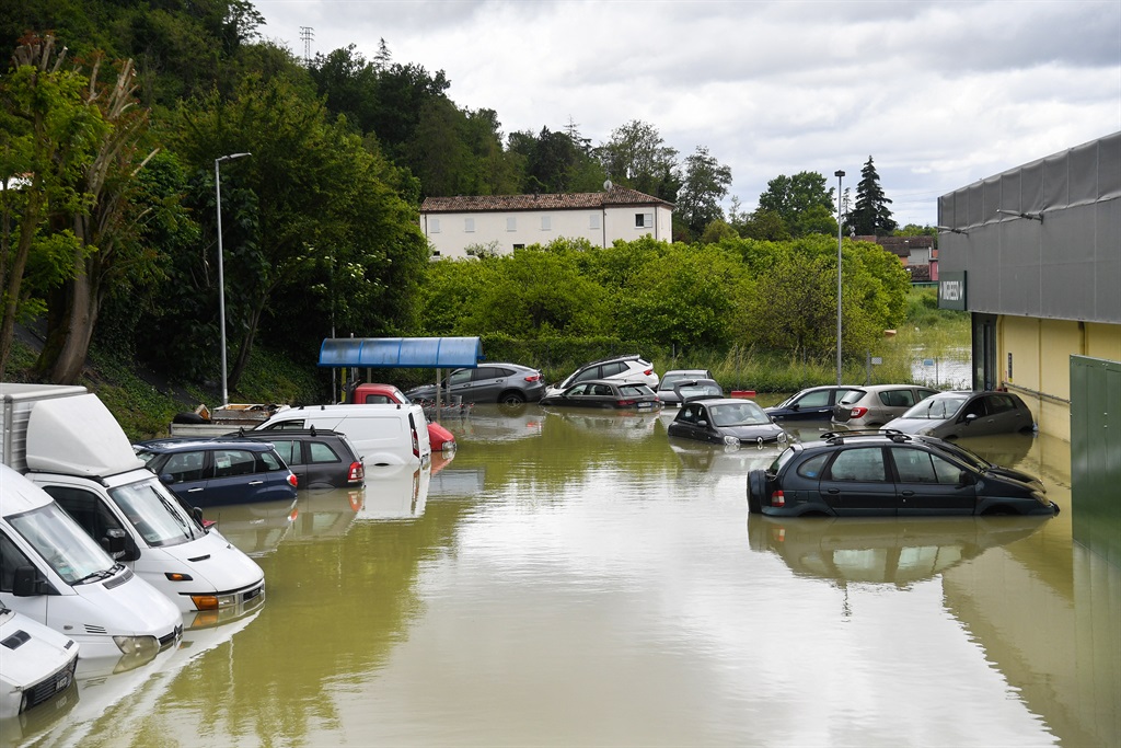 A general view shows vans and cars on a flooded su