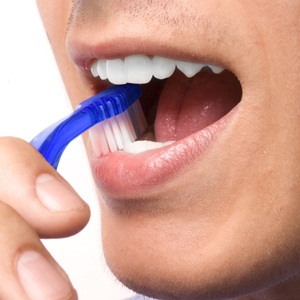 Man brushing teeth from Shutterstock