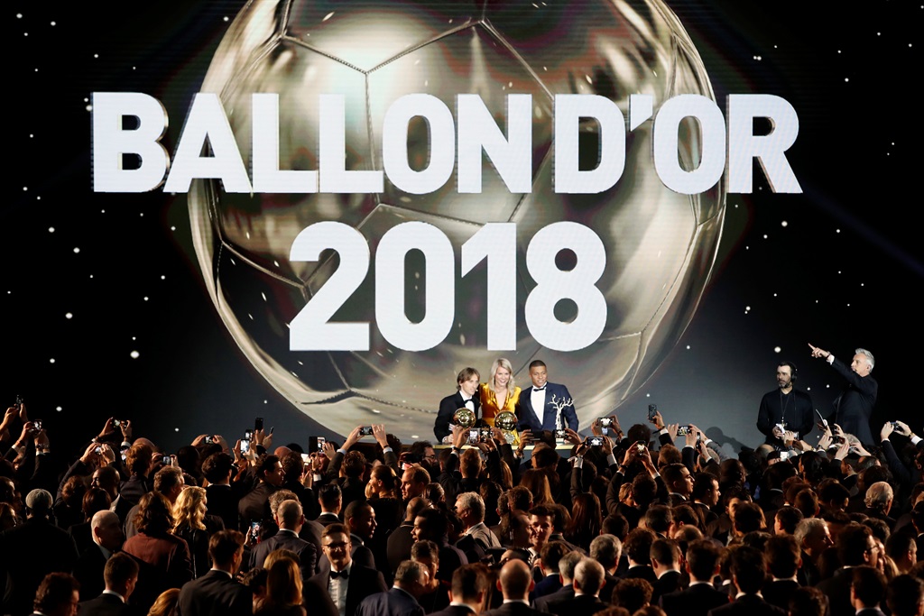 Olympique Lyonnais' Ada Hegerberg with the Women's Ballon d'Or (center) poses with Real Madrid's Luka Modric, with the Ballon d'Or (left) and Paris St Germain's Kylian Mbappe with the Kopa Trophy (right) during the Golden Ball award ceremony at the Grand Palais in Paris, France, on Monday (December 3 2018). Picture: Christophe Ena/AP