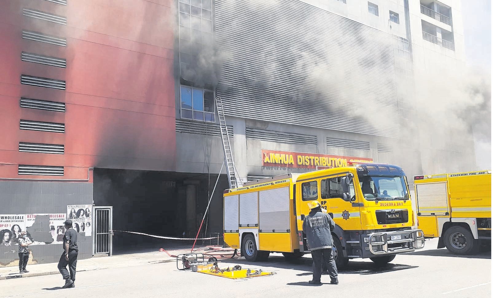 Firefighters battle a blaze at the Xinhua Distribution Centre in Durban central on Friday. 