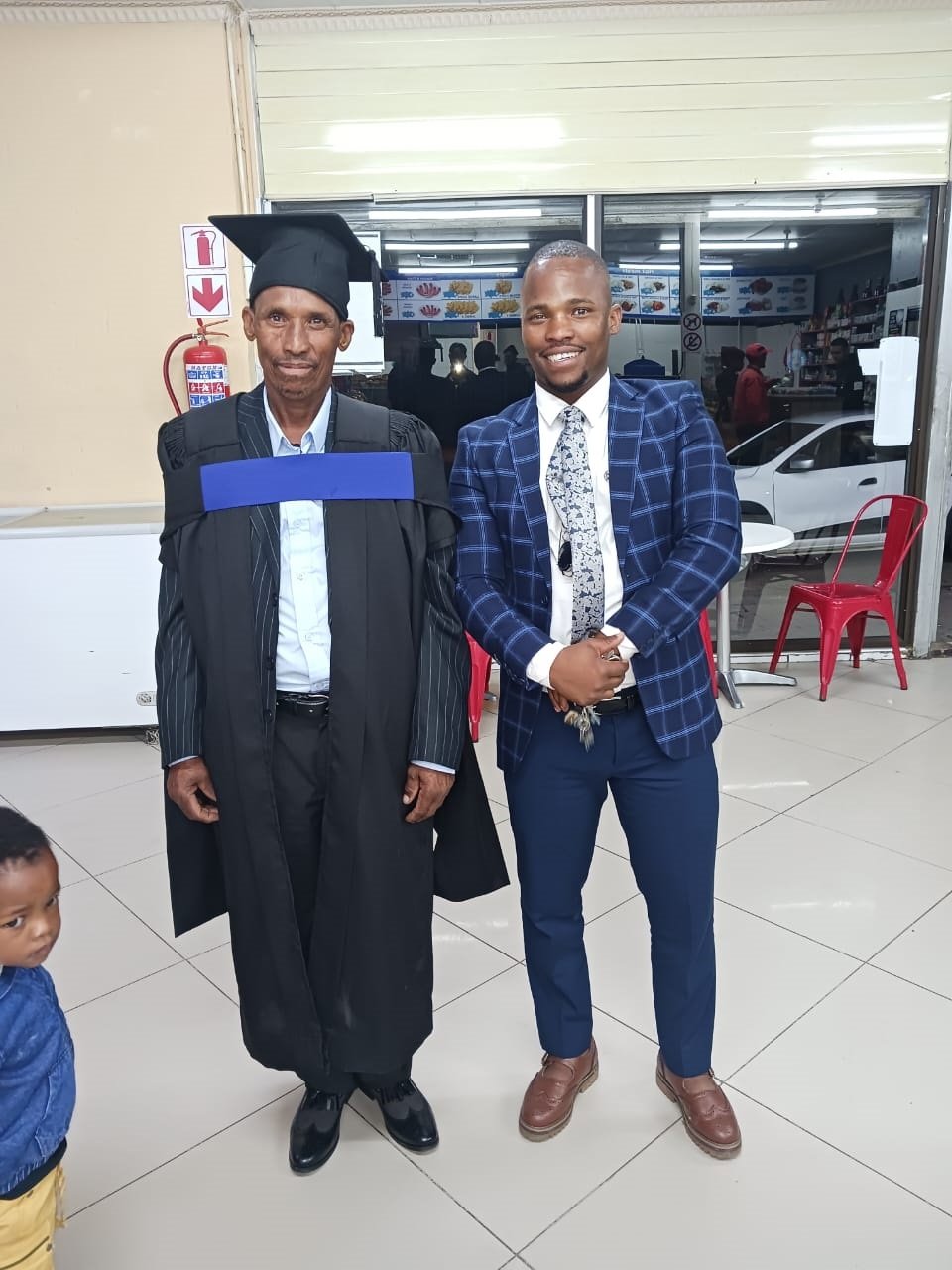 Victor Thambe at his graduation ceremony with his 