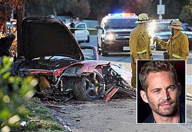 <b>'F&F' STAR WALKER KILLED:</b> First responders gather evidence from the burned Porsche that crashed into a pole in Valencia, California, killing 'Fast & Furious' star Paul Walker. <i>Image: AP/Santa Clarita Valley Signal/Dan Watson</i>