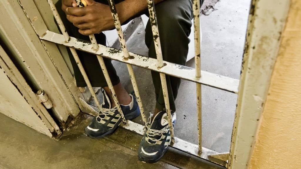 An inmate is pictured in his in cell in Pretoria's C-Max prison. 