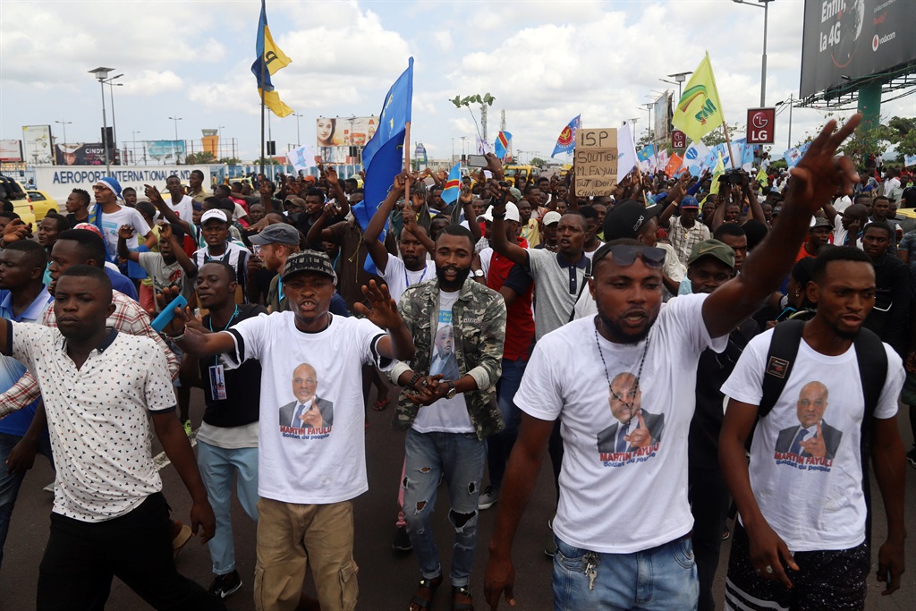Supporters of Congolese opposition presidential candidate Martin Fayulu chant slogans as they welcome him at N'djili International Airport in Kinshasa, Democratic Republic of Congo on November 21 2018. Picture: Kenny Katombe/Reuters