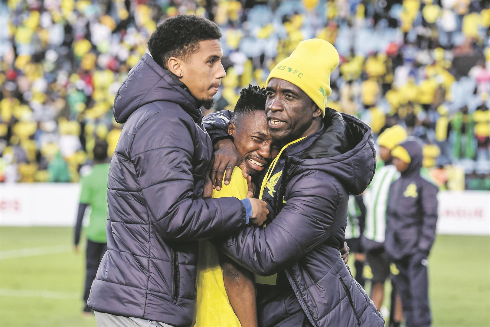 Distraught Mamelodi Sundowns starlet Cassius Mailula is comforted by David Notoane and Rushine De Reuck after their team was eliminated from the CAF Champions League by Wydad Athletic at Loftus Stadium in Pretoria yesterday PHOTO: Lefty Shivambu / Gallo Images