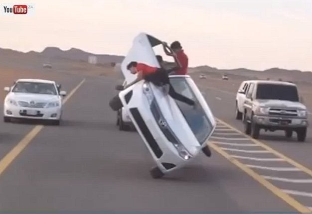 <b> WHY STOP TO CHANGE A TYRE? </b> Saudi Team Impossible changes two tyres while their Toyota balances on two wheels. <i>Image: YOUTUBE</i>