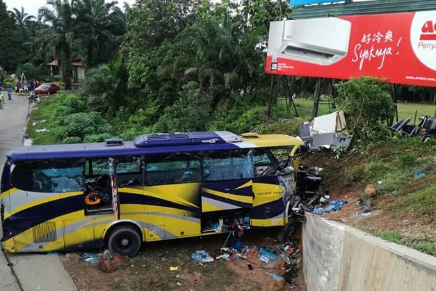The wreckage of a bus after it crashed in Muar,
