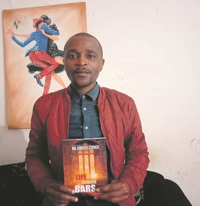 Ex-convict Mlungisi Zondi with a copy of his book,