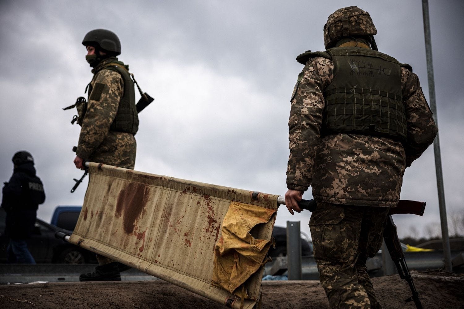 Ukrainian troops with a blood-stained stretcher. (Photo: Dimitar Dilkoff/AFP via Getty Images)