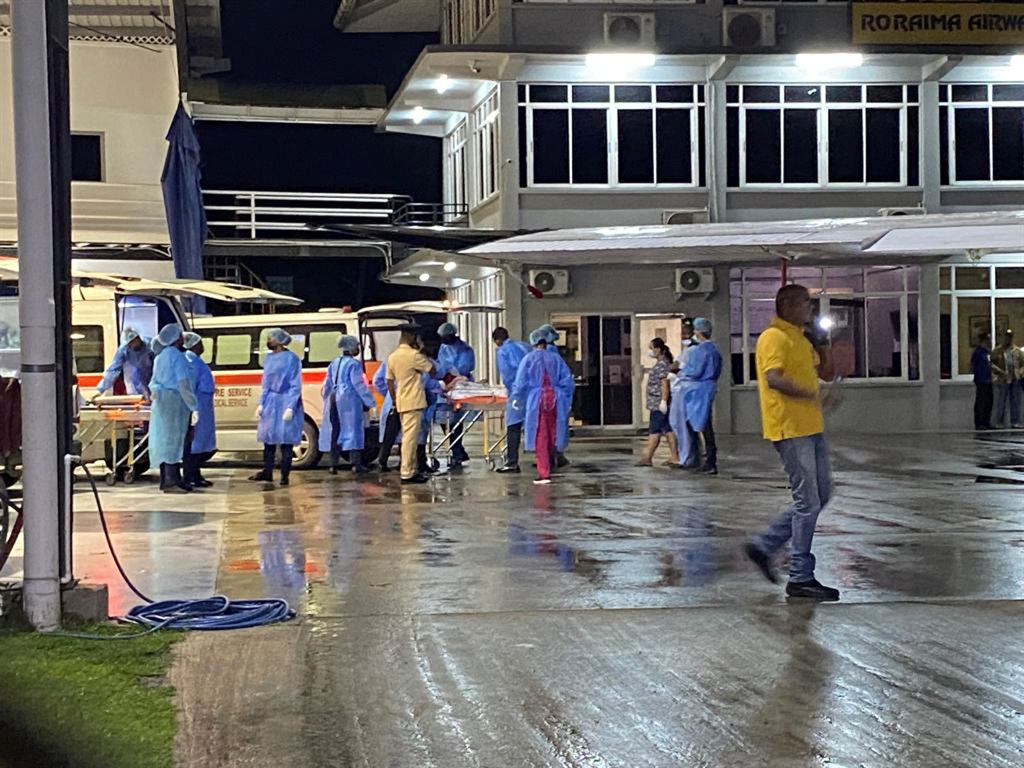 Children rescued during a Mahdia secondary school dormitory fire are transferred by medical personnel to hospitals in Gorgetown, Guyana on 22 May 2023. 