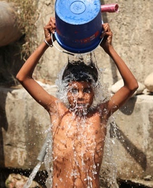 A boy tries to cool down in Jammu. (Channi Anand, AP)