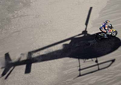 <b>PLAYING WITH SHADOWS:</b> Spanish biker Marc Coma looks like he's hitching a ride on a chopper with his KTM during the 2014 Rally Dakar Stage 9 between Calama and Iquique, Chile, on January 14, 2014. <i>image: AFP</i>