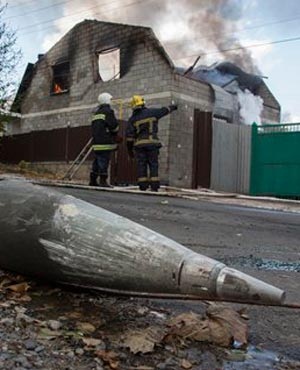 Part of a multiple missile 'Uragan', lies near a damaged private house after shelling in the town of Donetsk. (Dmitry Lovetsky, AP)