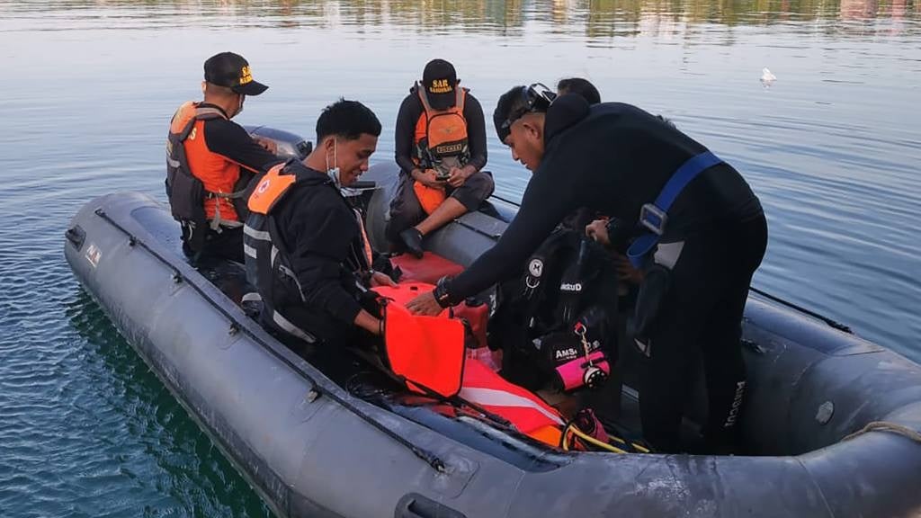 This handout photo from Indonesia's National Rescue Agency (Basarnas) shows members of a rescue team setting out to conduct search and rescue operations in Buton Tengah, Sulawesi after a ferry sank. 