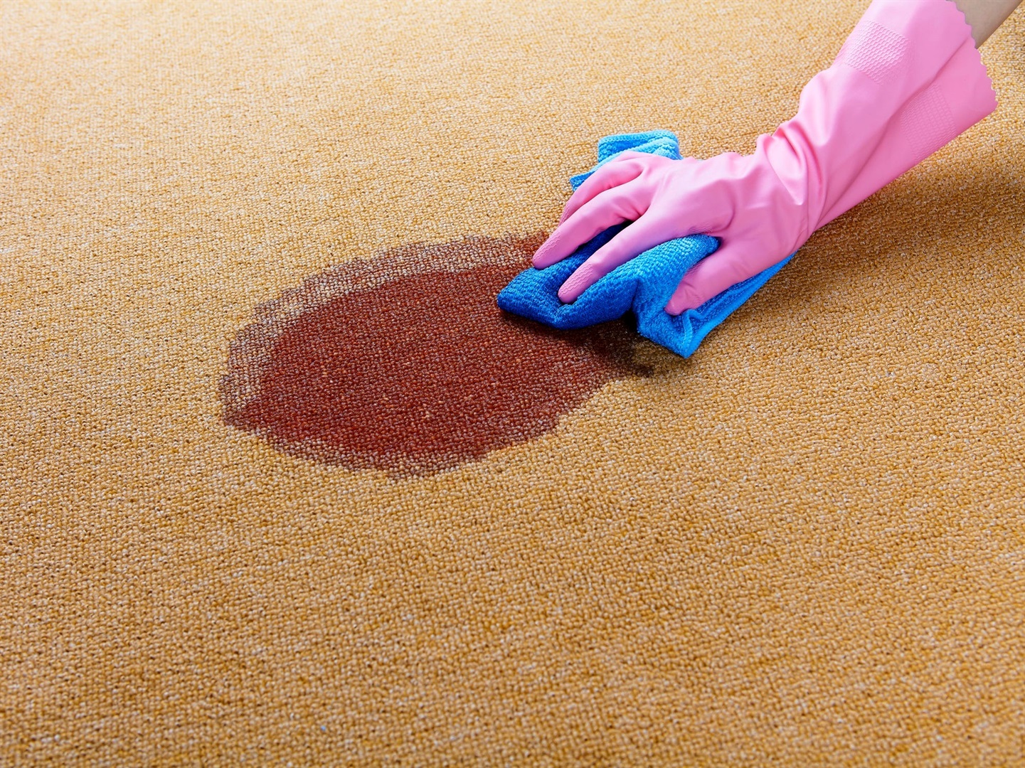 When removing stains on carpet, blot, don't scrub. pinstock/Getty Images
