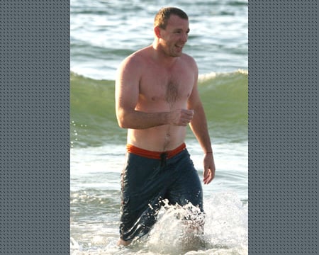The Virgo with shirtless athletic body on the beach
