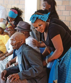 Students treat the shoulders of Nomzamo elders at a city council function in Cape Town. Picture: SKYE GROVE
