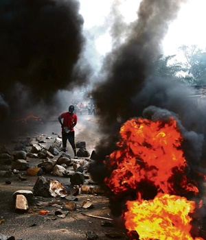 A man sets up a burning barricade to protest against Burundi President Pierre Nkurunziza’s bid for a third term in office. Picture: Reuters