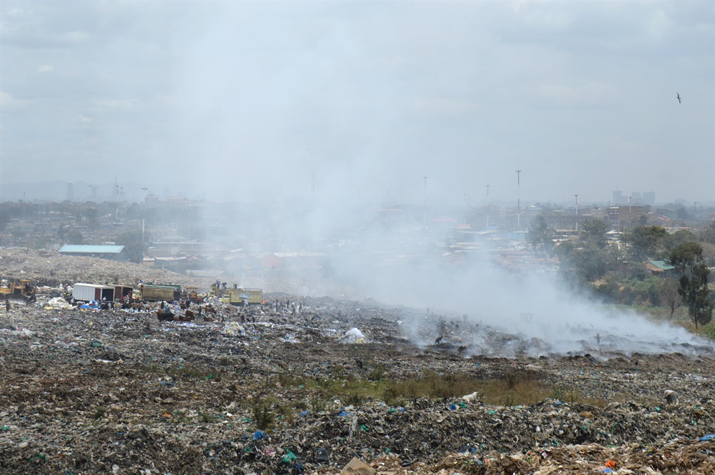Smoke is seen from burning waste in Nairobi's Dandora Dump site.