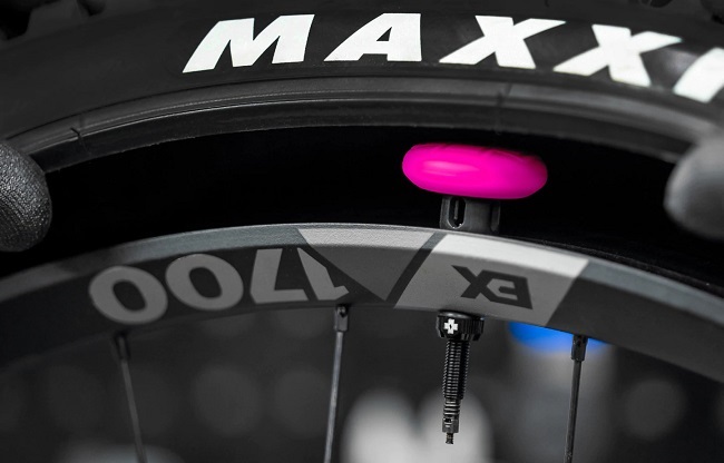
That pink silicone pouch, contains an AirTag. Hidden inside the tyre. (Photo: Muc-Off)

