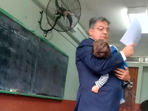 teacher holds baby 