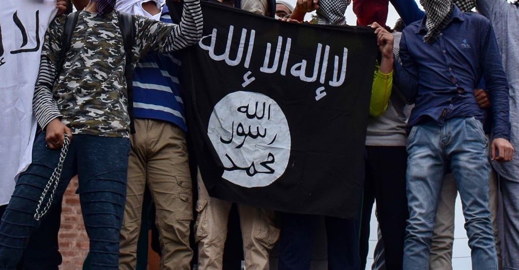 A group of men displaying the ISIS flag.