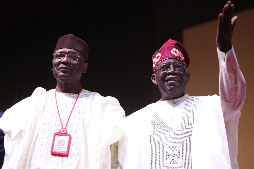 Nigeria’s President-elect Bola Tinubu (R) and Chairperson of the Independent National Election Commission (INEC), Yakubu Mahmood (L), look on during the presentation of the certificate of return to the President-elect by the INEC in Abuja on 1 March, 2023.