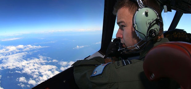 RAAF Flight Lieutenant looks out from the cockpit during a search mission for flight MH370 in the Southern Indian Ocean. (AFP)