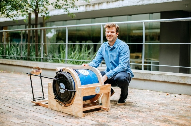 Kai Goodall puts his international award-winning, foot-cranked Pedal n Spin washing machine to work. (PHOTO: Supplied) 