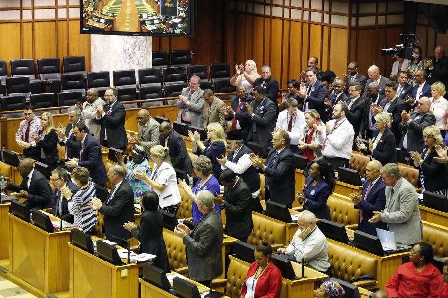 DA leader Mmusi Maimane (far left) is applauded by his party members after he spoke during a Parliament debate on a motion of no confidence in President Jacob Zuma. Picture: Schalk van Zuydam/AP