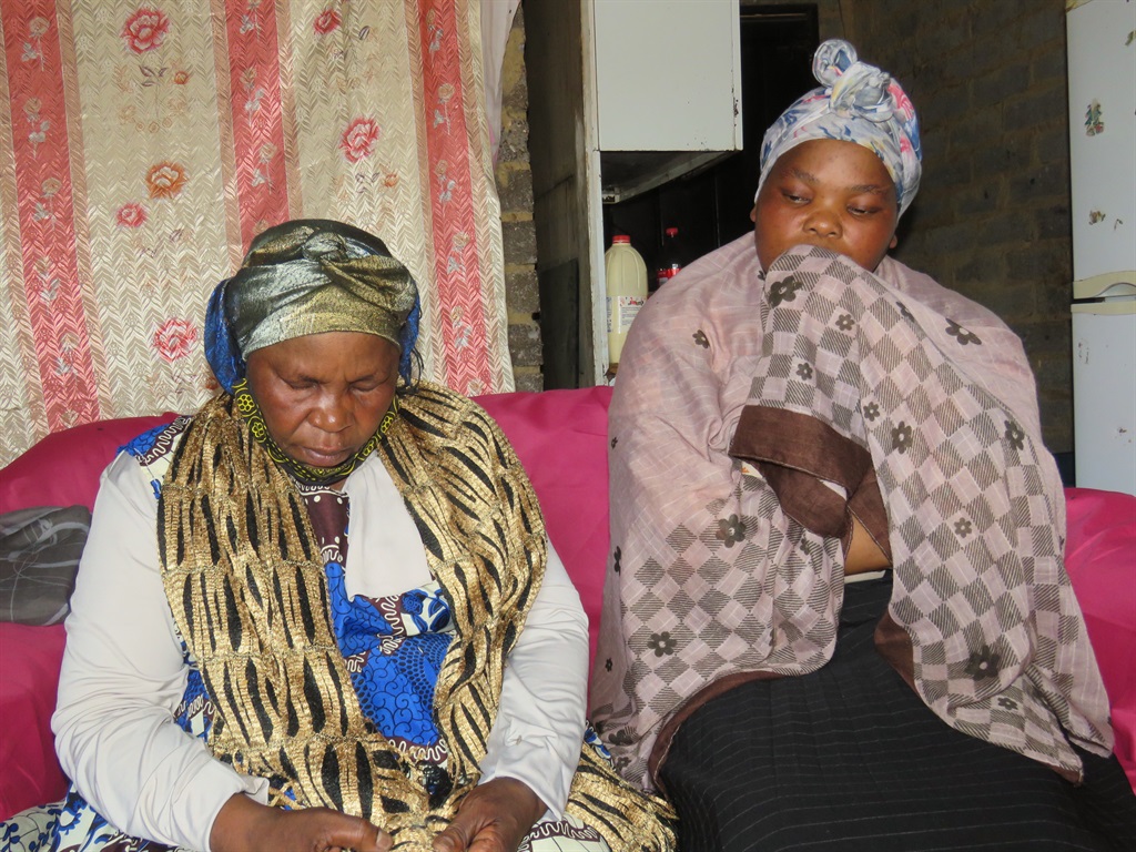 Gogo Matanzi Khumalo and her daughter grieving Zanele Khumalo who lost her son, Thembinkosi Ngema. Photo by Khaya Masipa