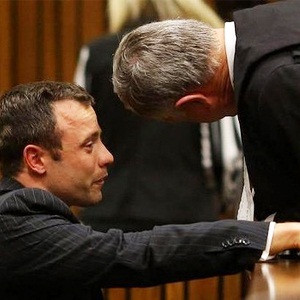Oscar Pistorius whispers into Barry Roux's ear
