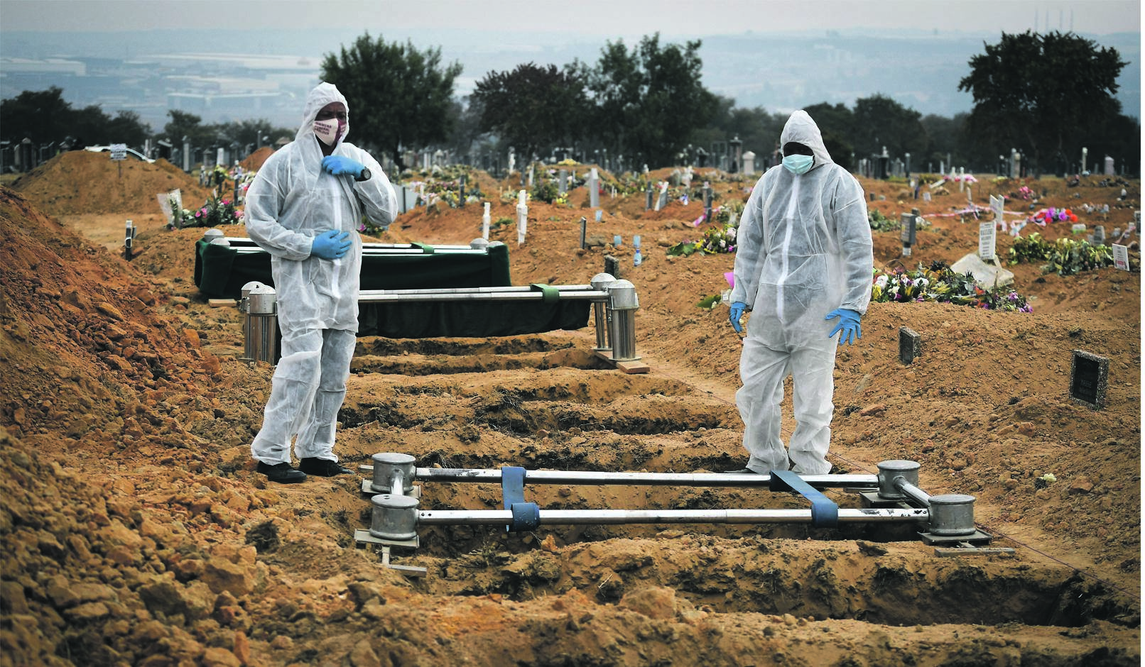 Funeral parlour staff prepare a grave for a victim of Covid-19 at Waterval Cemetery, Johannesburg.