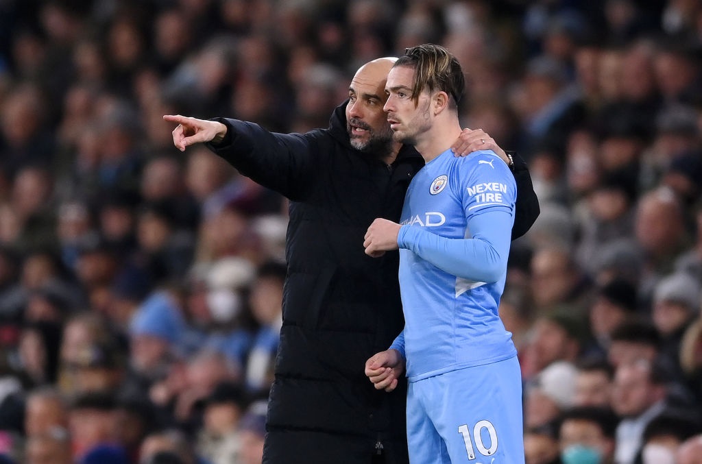 MANCHESTER, ENGLAND - FEBRUARY 09: Pep Guardiola gives instructions to Jack Grealish of Manchester City during the Premier League match between Manchester City and Brentford at Etihad Stadium on February 09, 2022 in Manchester, England. (Photo by Laurence Griffiths/Getty Images)