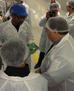 A Hisense technician explains the flat screen TV manufacturing process to MEC Donald Grant at the factory in Atlantis. (Duncan Alfreds, News24)