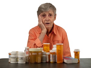 Elderly woman overwhelmed by medication from Shutterstock 