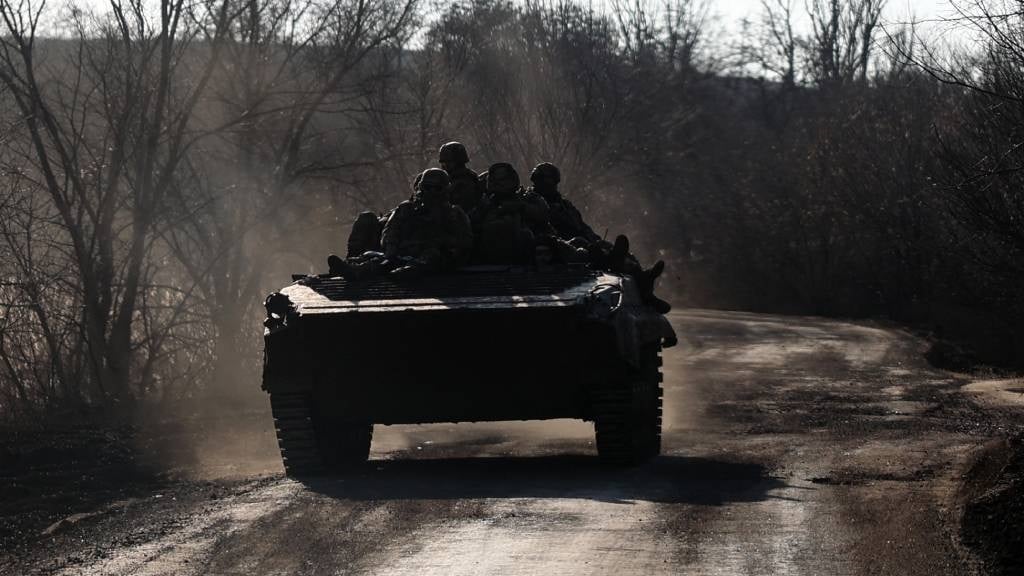 Ukrainian soldiers ride an infantry fighting vehic