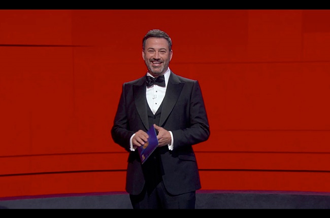 Jimmy Kimmel in front of a wall of nominees watching remotely at the Staples Center during the 72nd Primetime Emmy Awards ceremony held virtually. 
