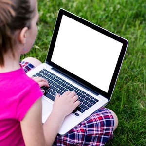 A child using a laptop from Shutterstock.