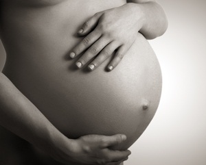 belly of pregnant woman monochrome on a dark background from Shutterstock