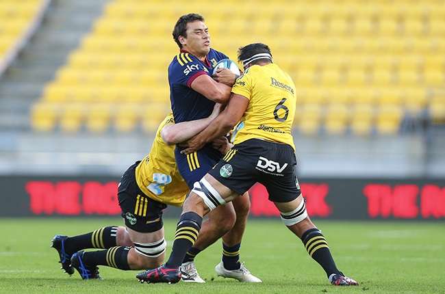 Highlanders back Thomas Umaga-Jensen of the Highlanders is tackled during the Super Rugby Pacific match between the Hurricanes and the Highlanders.