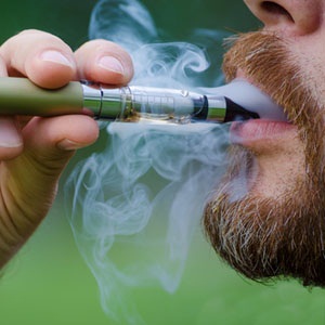 Close-up of a man vaping an electronic cigarette from Shutterstock. 