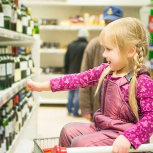 Child looking at alcohol from Shutterstock. 